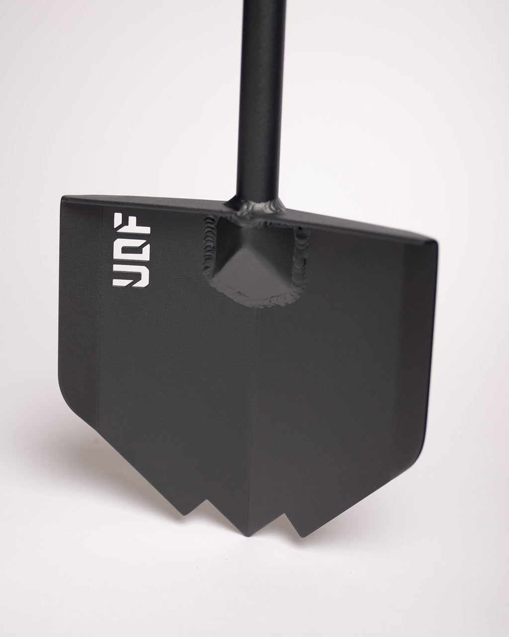 Close-up of the black shovel blade showing the welded handle joint and pointed tip