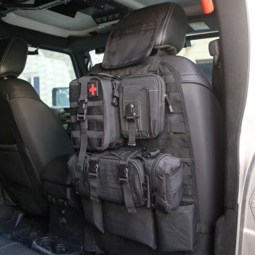 Black tactical back-seat organizer with detachable pouches strapped to the back of a front seat